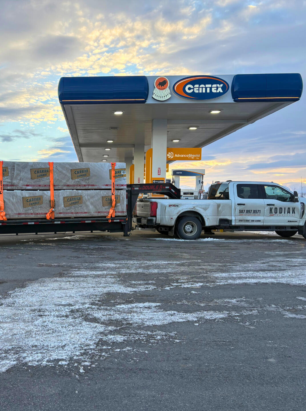 Kodiak Transport gooseneck trailer and F-350 rig parked in Alberta, showcasing heavy-duty hauling setup.